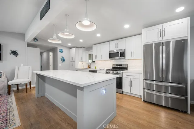 a kitchen with stainless steel appliances a refrigerator stove microwave and cabinets