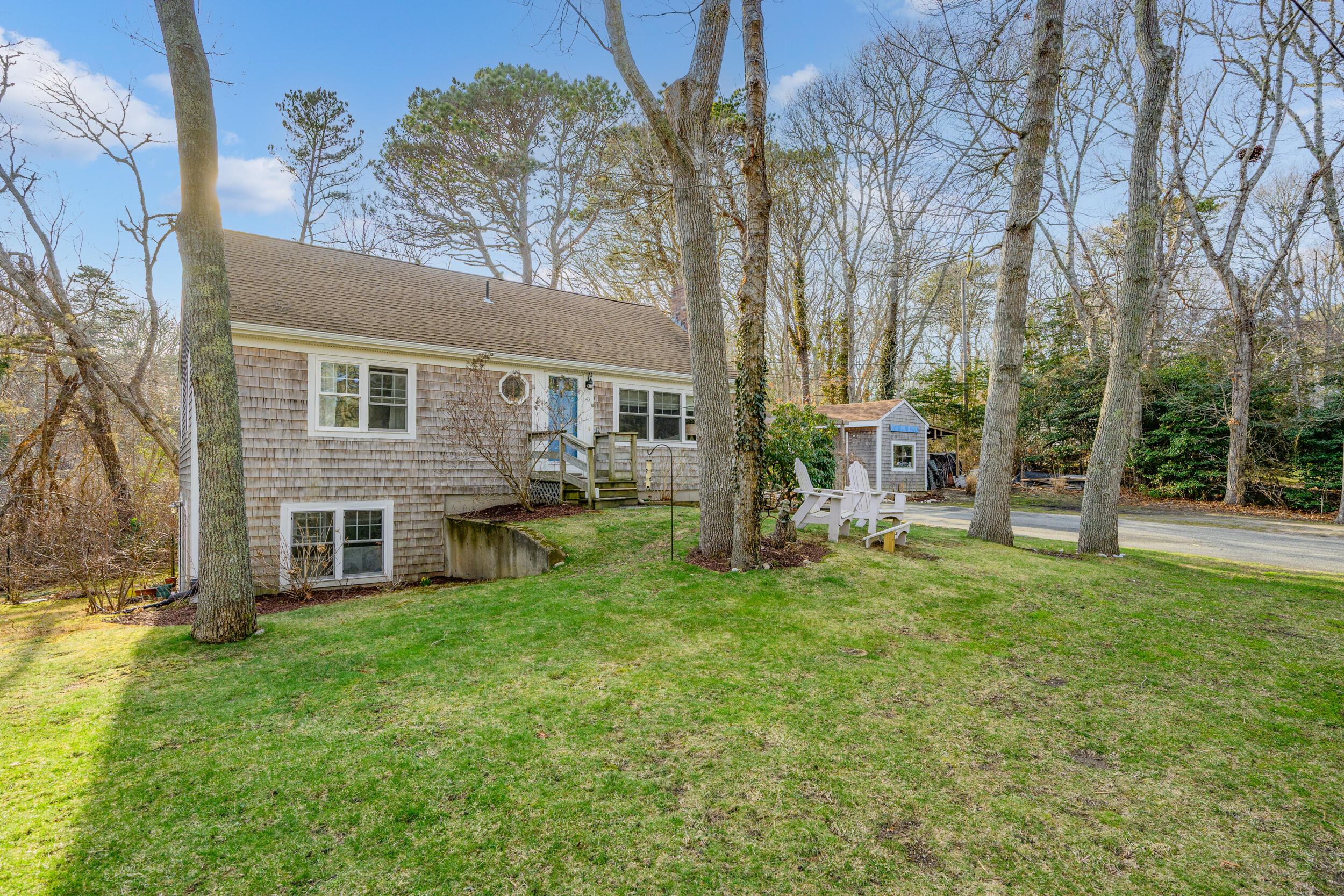 a view of a house with a yard and a tree