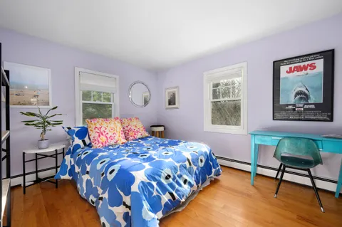 a bedroom with a bed and a chair