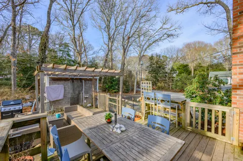 a view of deck with table and chairs and wooden floor