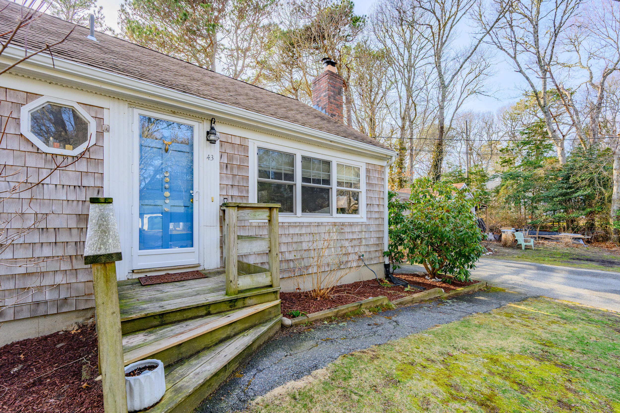 43 Chickadee Lane Centerville, MA 02632 - Photo 42 of 48 a view of backyard with a chair and potted plants