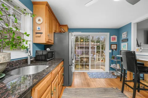 a kitchen with granite countertop a sink and a stove top oven