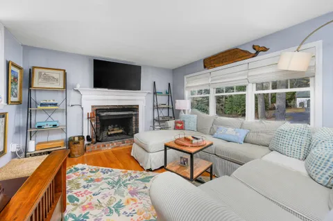 a living room with furniture a rug and a fireplace