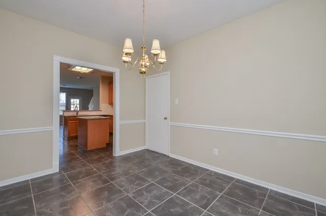 wooden floor in an empty room and a kitchen