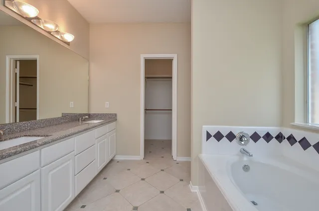 a bathroom with a bathtub and a sink