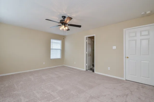 a view of room with a ceiling fan
