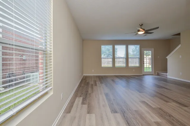 wooden floor in an empty room with a window