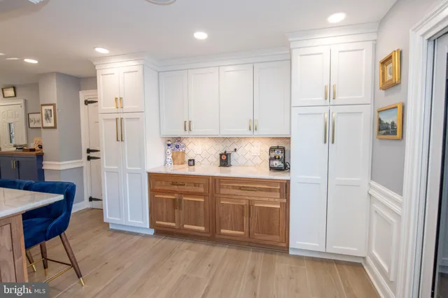 a kitchen with white cabinets and white appliances