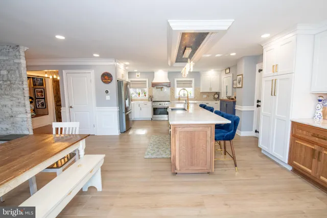 a living room with furniture and kitchen view