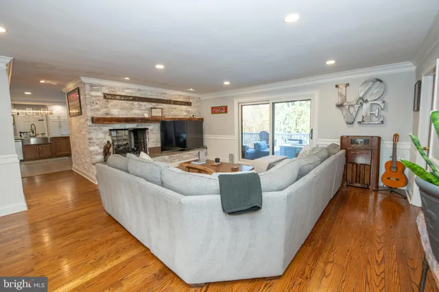 a living room with furniture and kitchen view