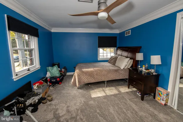 a bedroom with a bed and a television