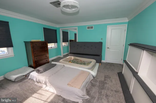 a view of a house with a yard and pathway