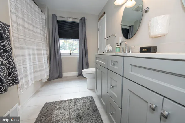 a view of a big house with a big yard and large trees