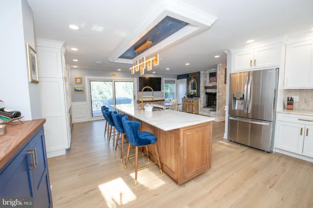 a kitchen with a sink cabinets and wooden floor