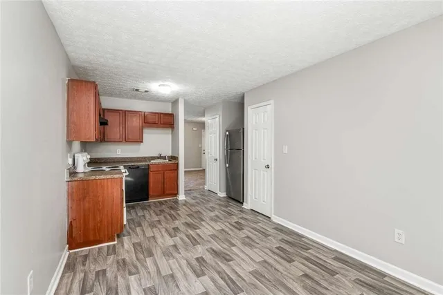 a kitchen with stainless steel appliances granite countertop a stove a sink and a refrigerator