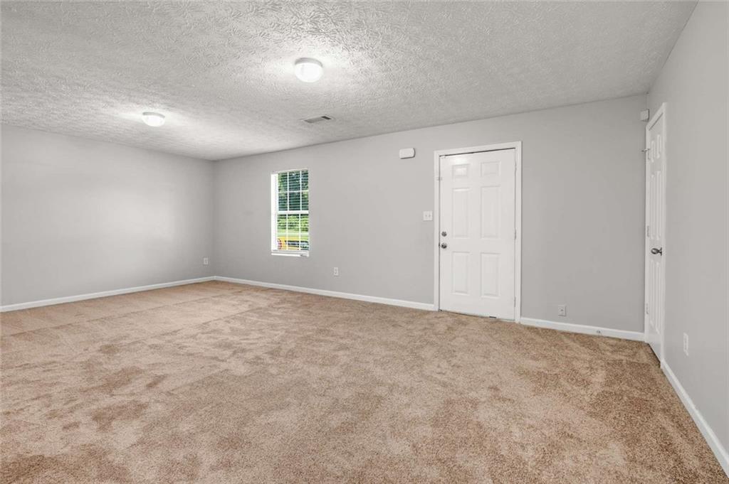 588 Elles Way Griffin, GA 30223 - Photo 6 of 32 an empty room with windows and closet
