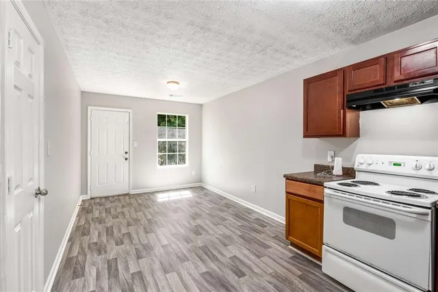 a kitchen with a stove and a microwave