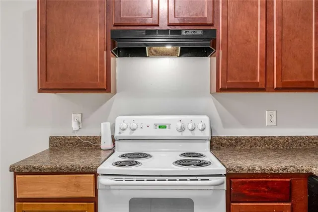 a kitchen with a stove and a cabinets