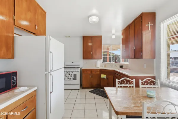 a kitchen with a stove a sink and a refrigerator