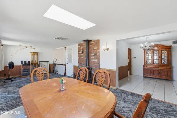 a dining room with furniture a rug and wooden floor