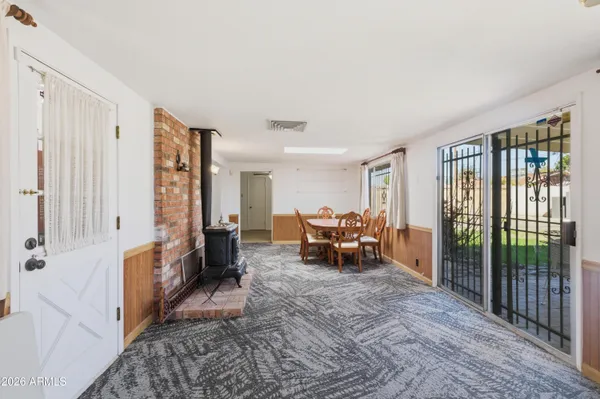 a living room with furniture a wooden floor and next to a window