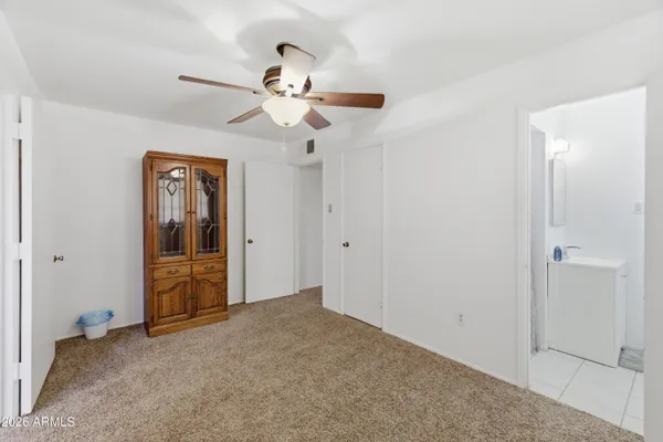 a view of empty room with window and ceiling fan