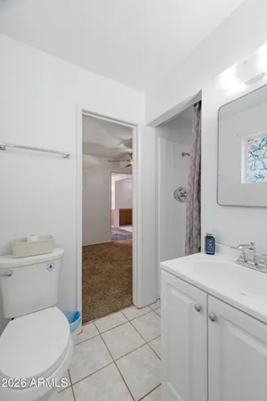 a bathroom with a toilet a sink and shower