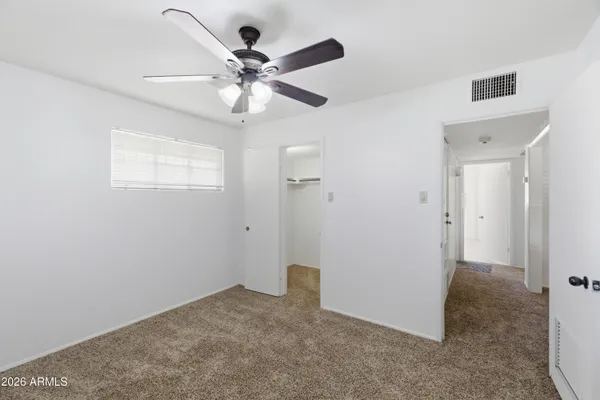 a living room with furniture ceiling fan and a window