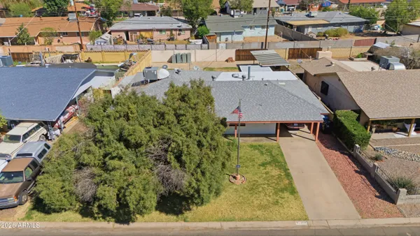 an aerial view of a house with a yard