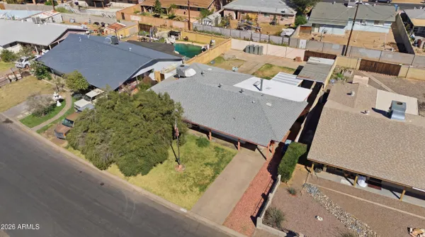 an aerial view of a house with a yard