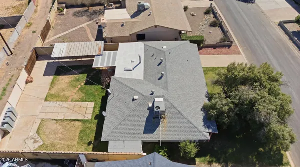 an aerial view of a house with a yard
