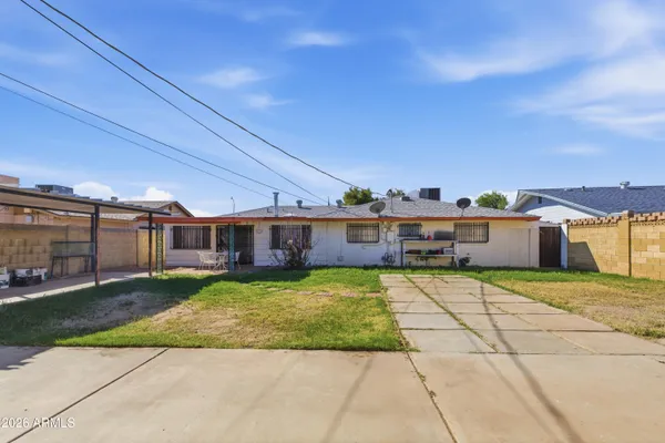 a view of a patio with table and chairs under an umbrella