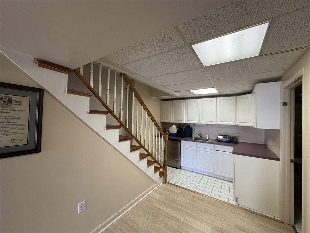 38 Crescent Road, Unit 38 Needham, MA 02494 - Photo 11 of 23 a kitchen with stainless steel appliances kitchen island granite countertop a refrigerator a stove a sink and dishwasher with wooden floor
