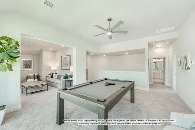 a living room with stainless steel appliances granite countertop furniture rug and white walls