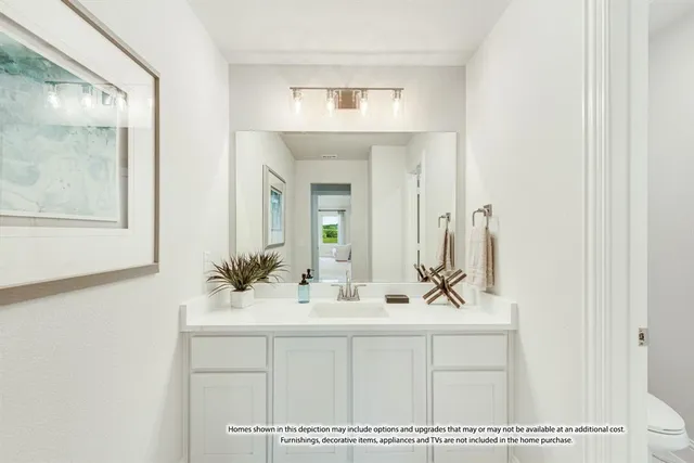 a bathroom with a sink a mirror and a vanity