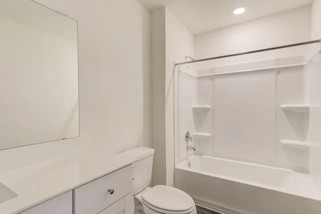 a bathroom with a shower a toilet and a bathtub