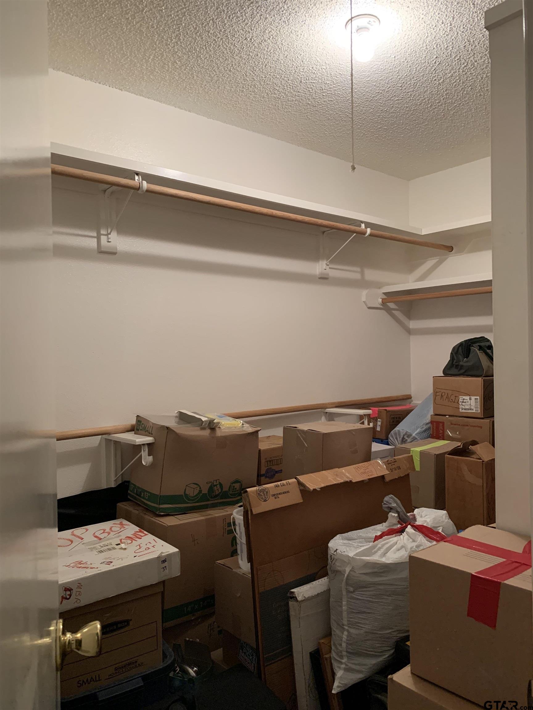 126 Wildwood Trail Holly Lake Ranch, TX 75765 - Photo 7 of 9 a utility room with dryer washer and empty racks