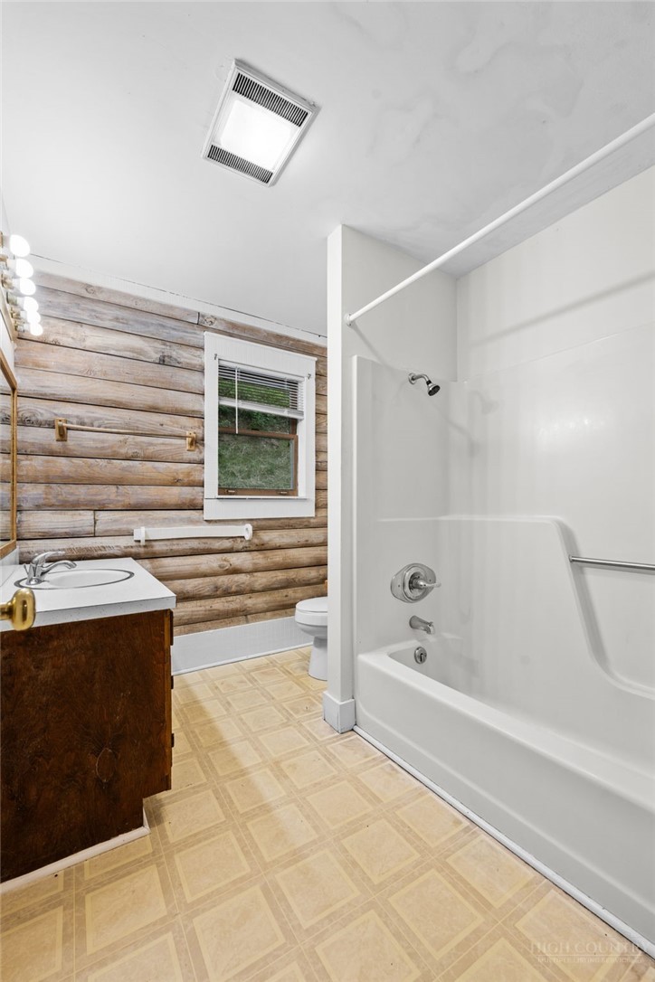 233 Alpine Acres Road Vilas, NC 28692 - Photo 19 of 32 a bathroom with a bathtub and a shower