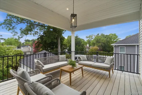 a balcony with furniture and wooden floor