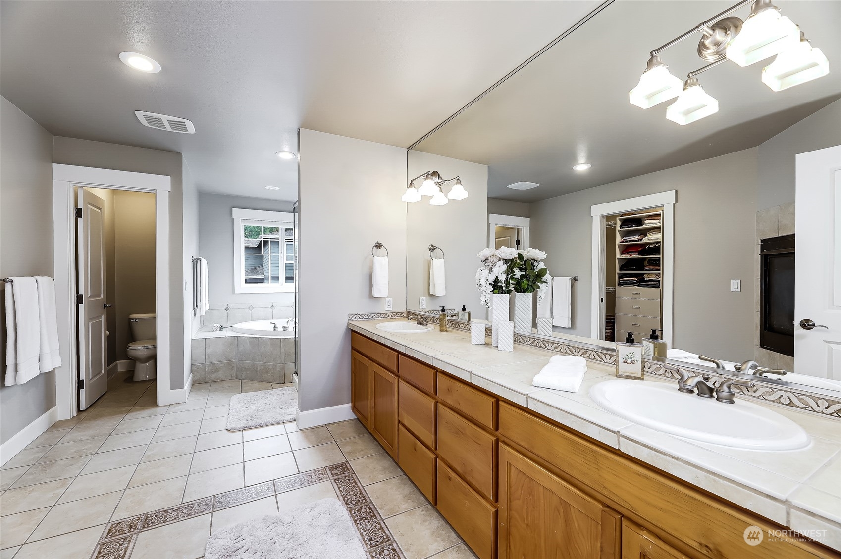 2712 Williams Avenue North Renton, WA 98056 - Photo 16 of 36 a spacious bathroom with a granite countertop sink a mirror and a shower