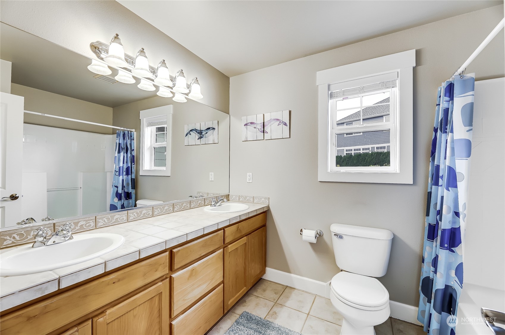 2712 Williams Avenue North Renton, WA 98056 - Photo 22 of 36 a bathroom with a granite countertop toilet sink and mirror