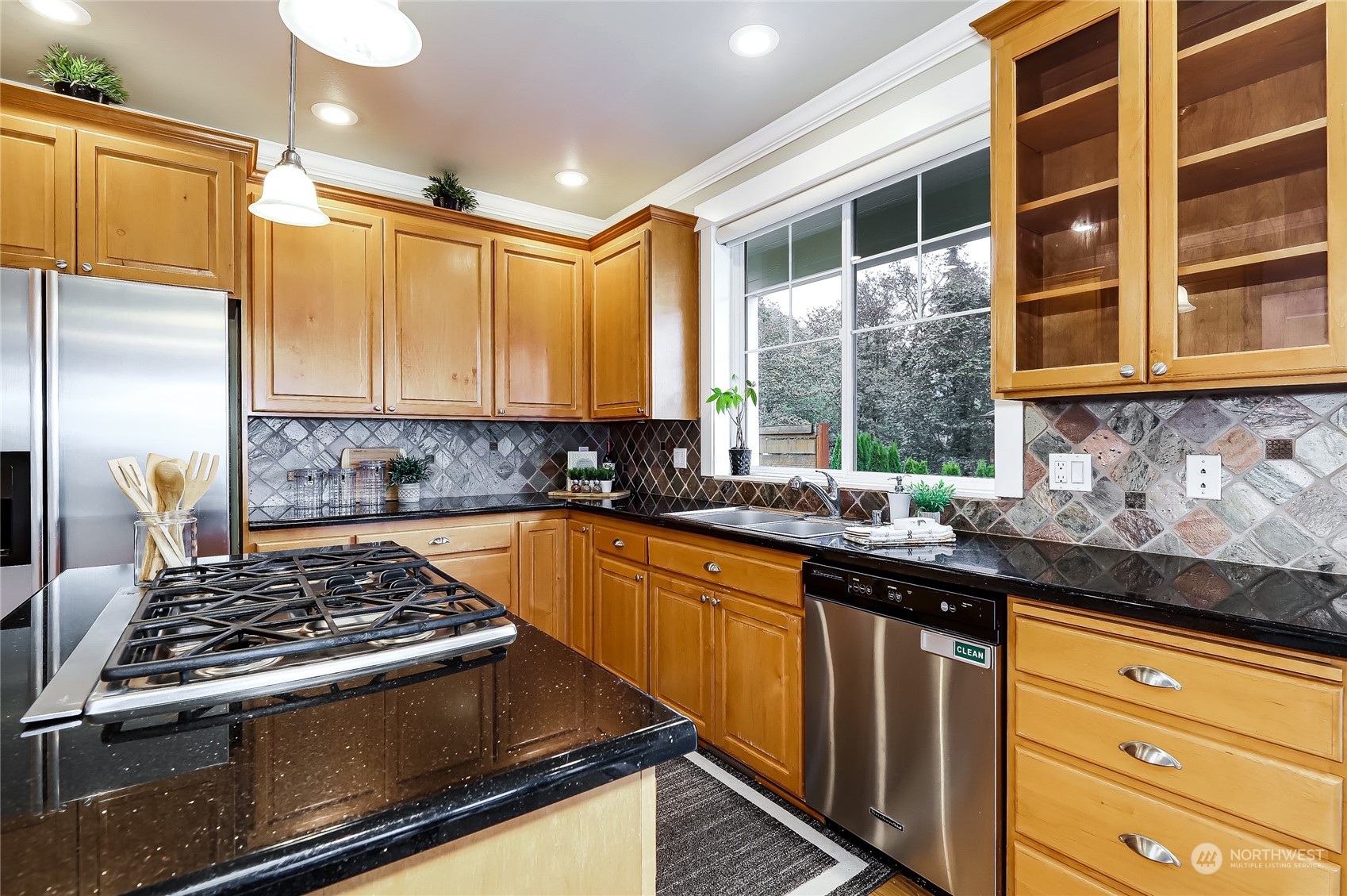 2712 Williams Avenue North Renton, WA 98056 - Photo 9 of 36 a kitchen with granite countertop stainless steel appliances a sink stove and cabinets