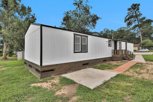 a backyard of a house with wooden fence and trees