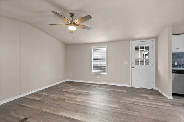 wooden floor in an empty room with a window