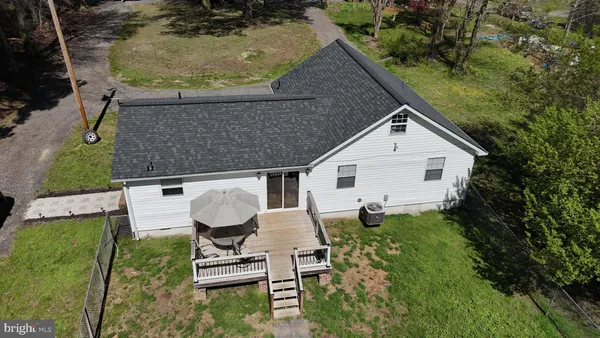 an aerial view of a house with garden space and street view