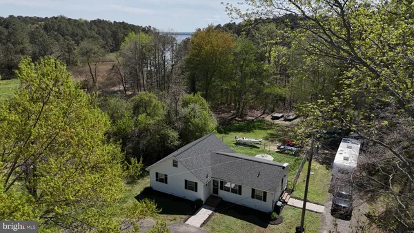 an aerial view of a house with a yard