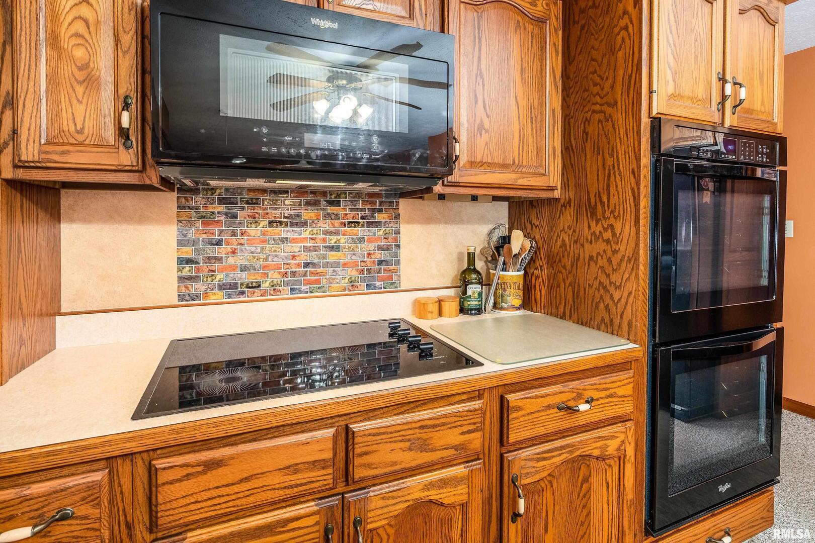 11688 Strawberry Road Carbondale, IL 62901 - Photo 21 of 36 a kitchen with a stove and a microwave