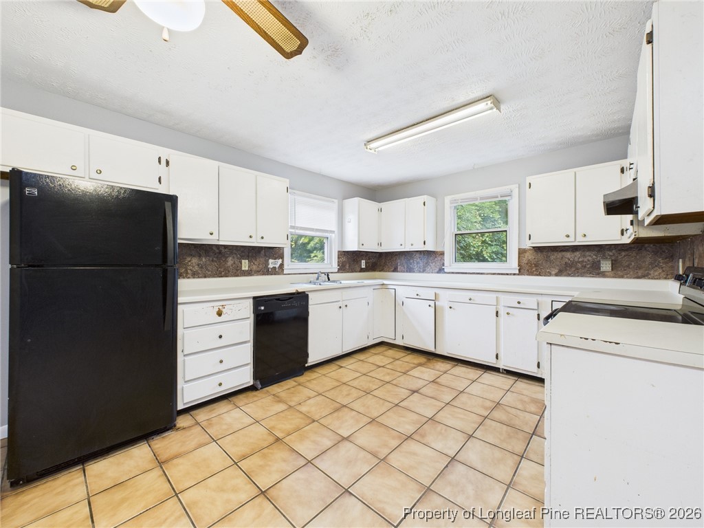 1540 Mack Street Spring Lake, NC 28390 - Photo 11 of 31 a kitchen with white cabinets and white appliances