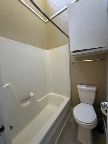 a bathroom with a toilet and a bathtub