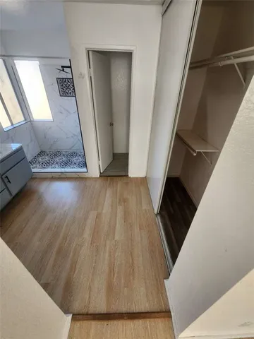 a view of a hallway view with wooden floor and staircase